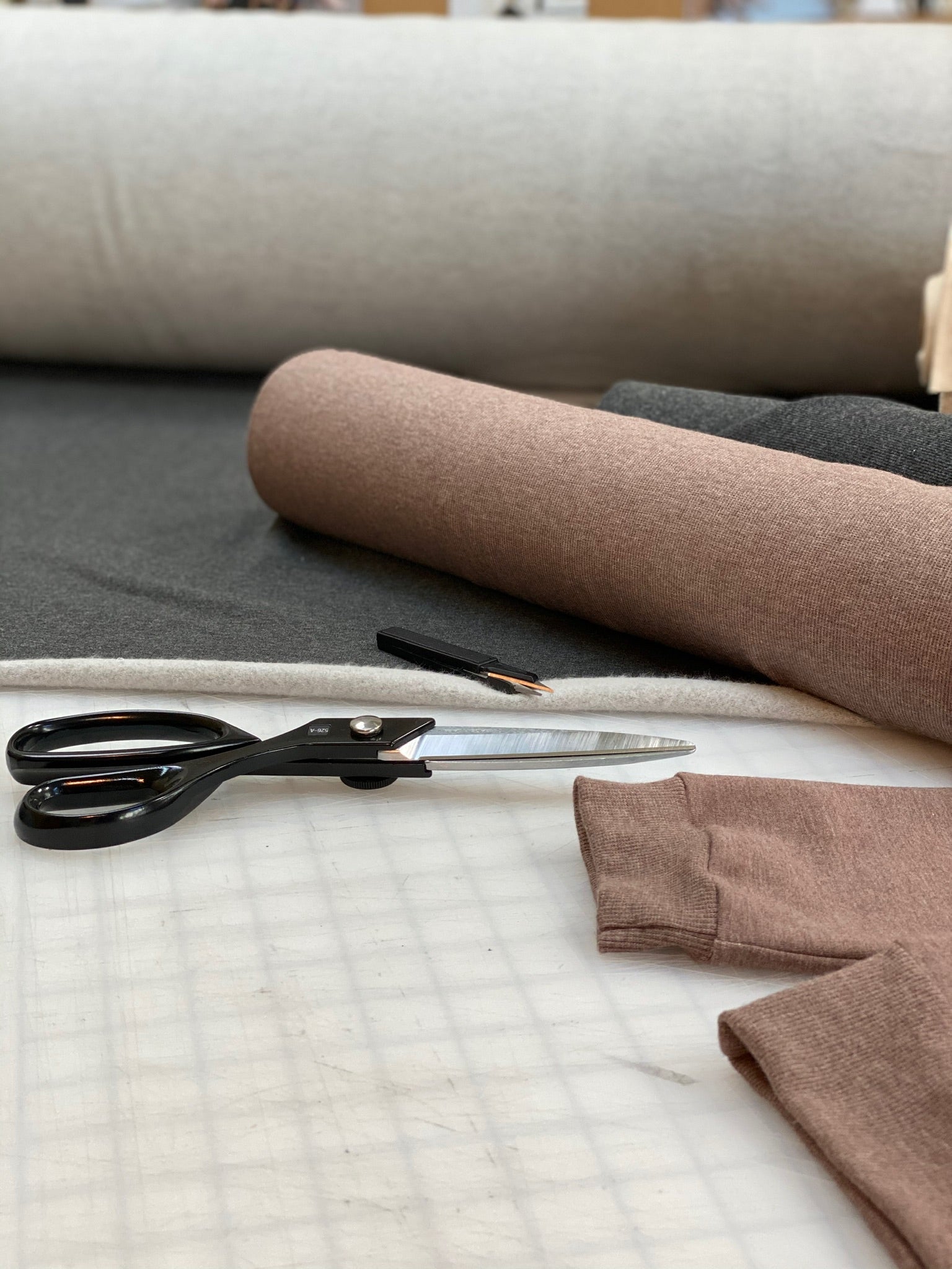 Responsibly sourced bamboo cotton fabric on cutting table at sustainable clothing studio, Lacson Ravello